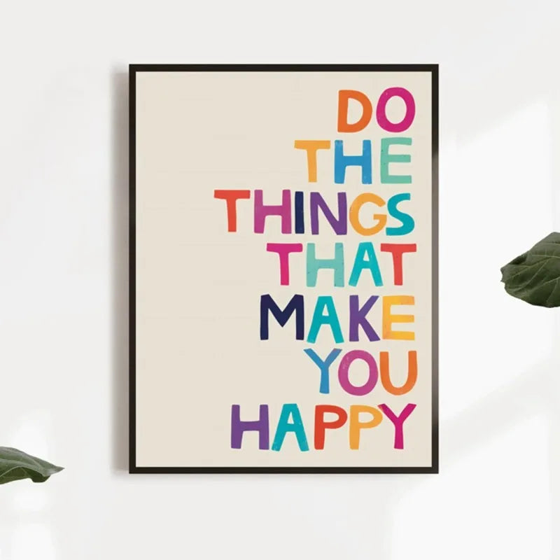 Framed poster with motivational quote 'Do the things that make you happy' in colorful letters on a white wall.