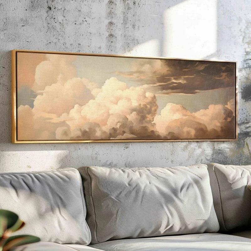 Framed artwork of clouds above a sofa with a neutral color scheme.