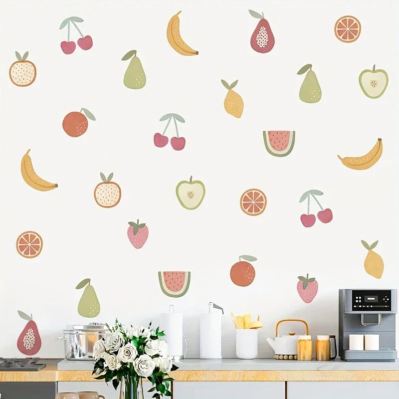 Kitchen counter with fruit-themed wall decals on a white wall.