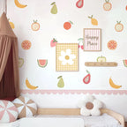 Children's room with fruit-themed wallpaper, bed, and decorative pillows.