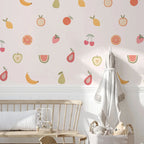 Children's room with fruit-patterned wallpaper, wooden crib, and toys.