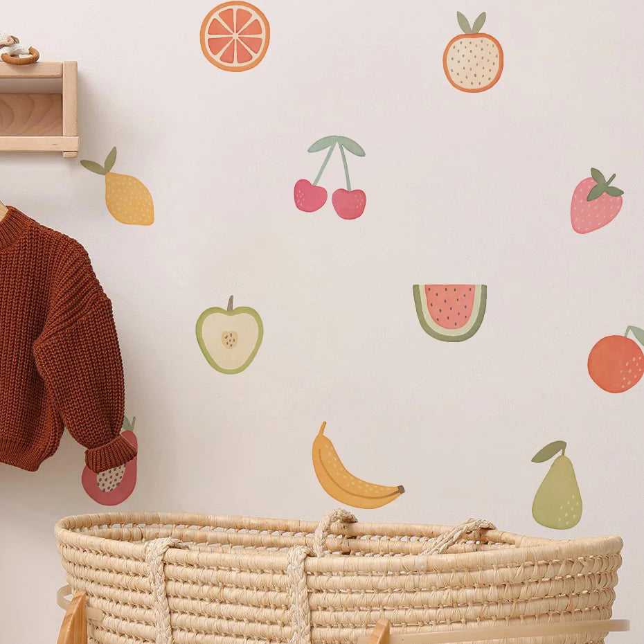 Wall with fruit decals and a basket below