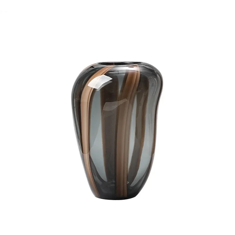 Glass vase with brown and black striped design on a white background