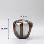 Glass vase with brown and clear stripes and measurements on a white background