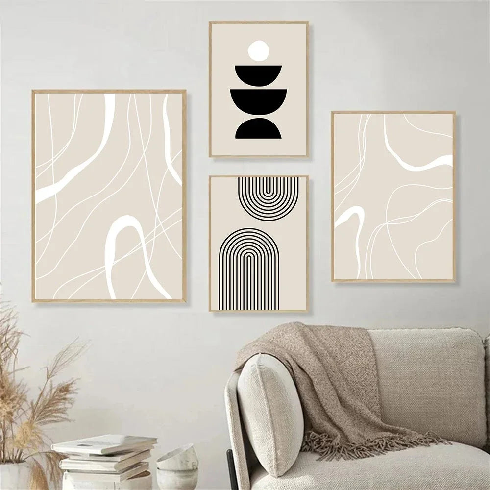 Set of four abstract art prints on a wall above a sofa.