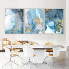 Dining room with abstract blue and gold wall art above a table and chairs.