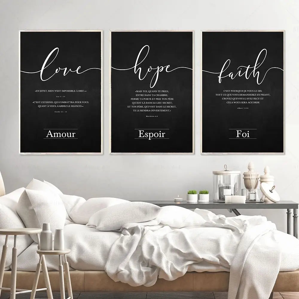 Three framed prints with motivational phrases on a wall above a bed.