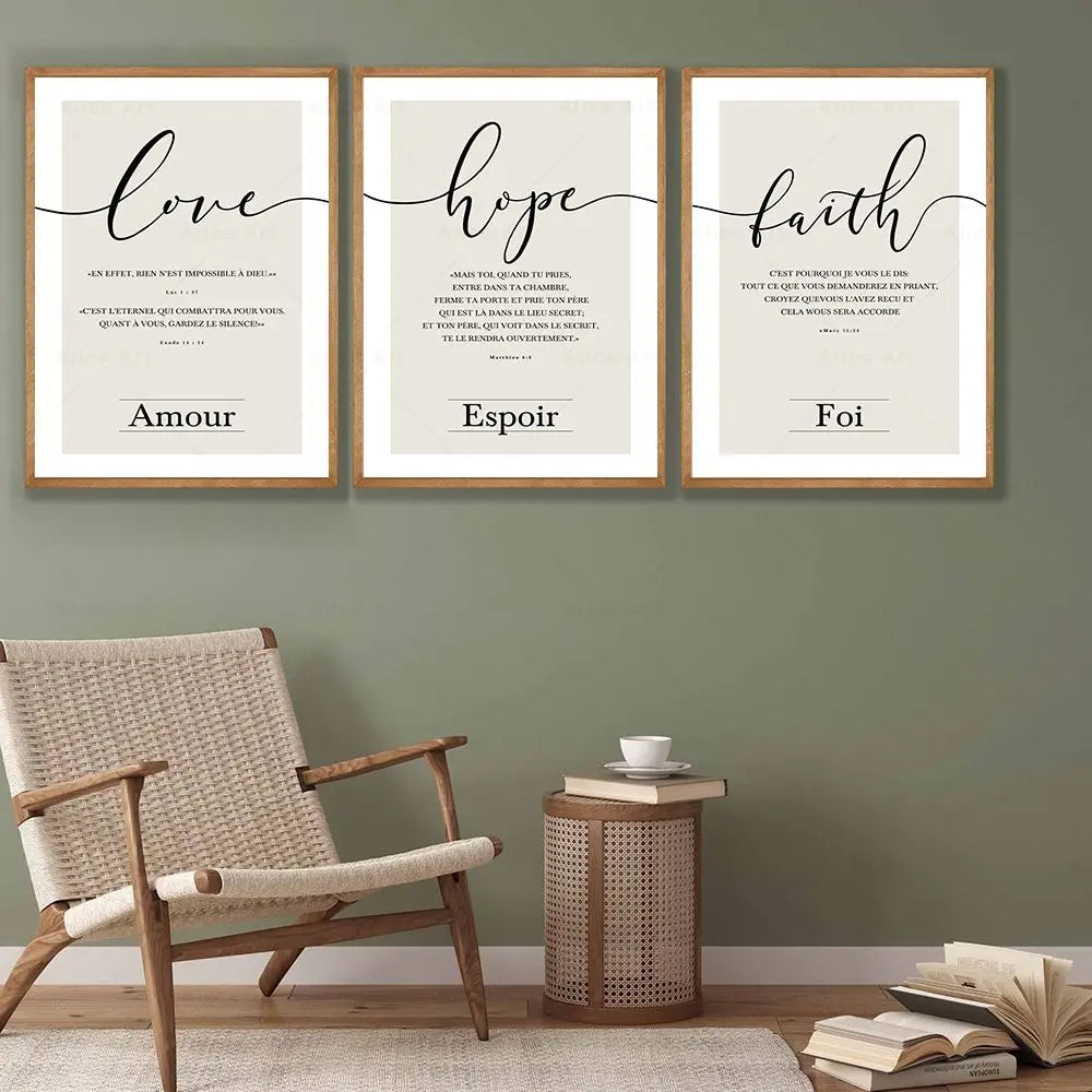 Three framed prints on a wall with 'love', 'hope', and 'faith' text, accompanied by a chair and side table.
