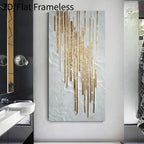 A vertical rectangular wall art piece with a textured off-white background and metallic gold vertical drip-like lines, displayed in a bathroom setting next to a sink and mirror.