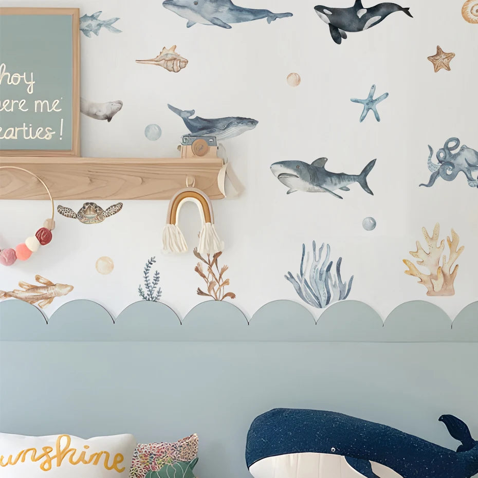 Children's room with ocean-themed wallpaper, toys, and decor.