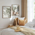 Cozy bedroom with a bed, pillows, and framed pictures on the wall.