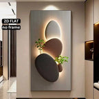 Decorative wall art with three-dimensional stone-like shapes and plants on a neutral wall.