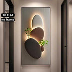Decorative wall art with stones and plants on a neutral wall.