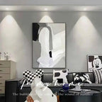 Modern living room with abstract art and decorative pillows.