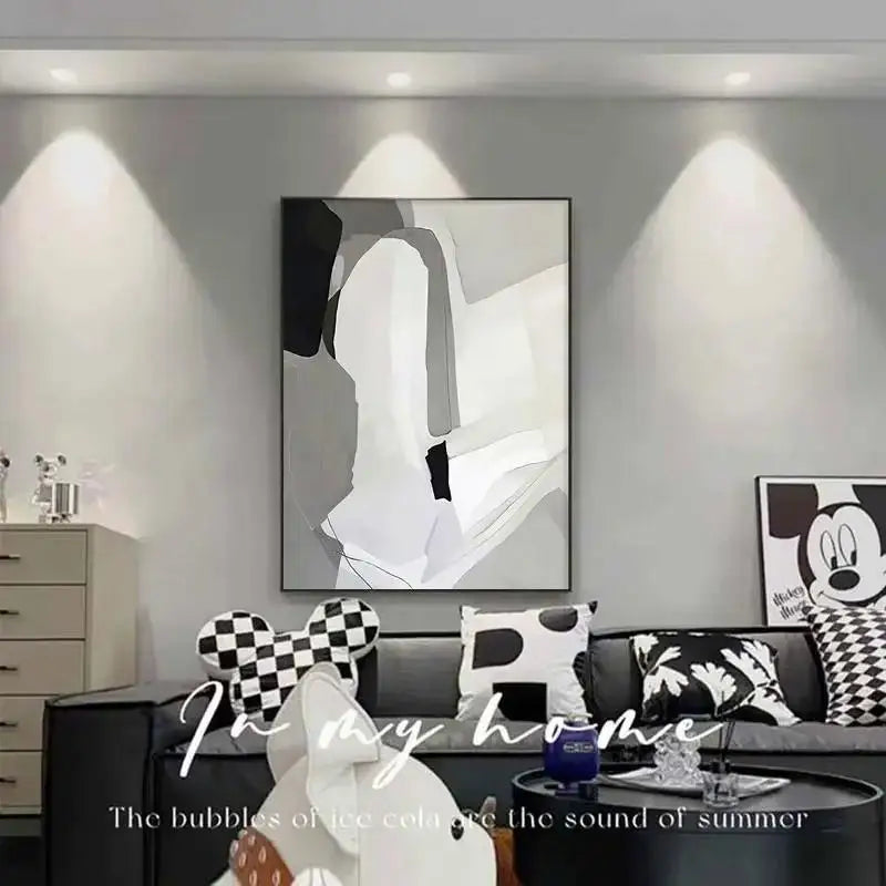 Modern living room with abstract art and decorative pillows.