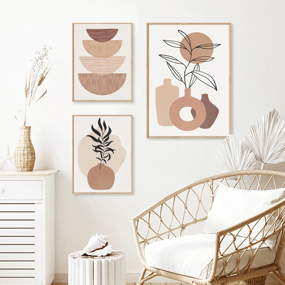 Decorative wall art in a living room with a wicker chair and white walls.