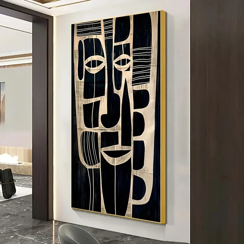 Abstract wall art with black and beige design on a white wall.