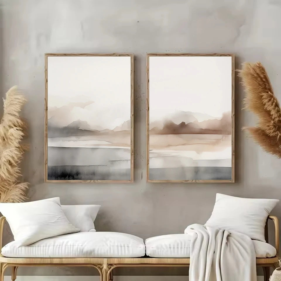Two abstract wall art pieces above a bench with decorative pillows and pampas grass.