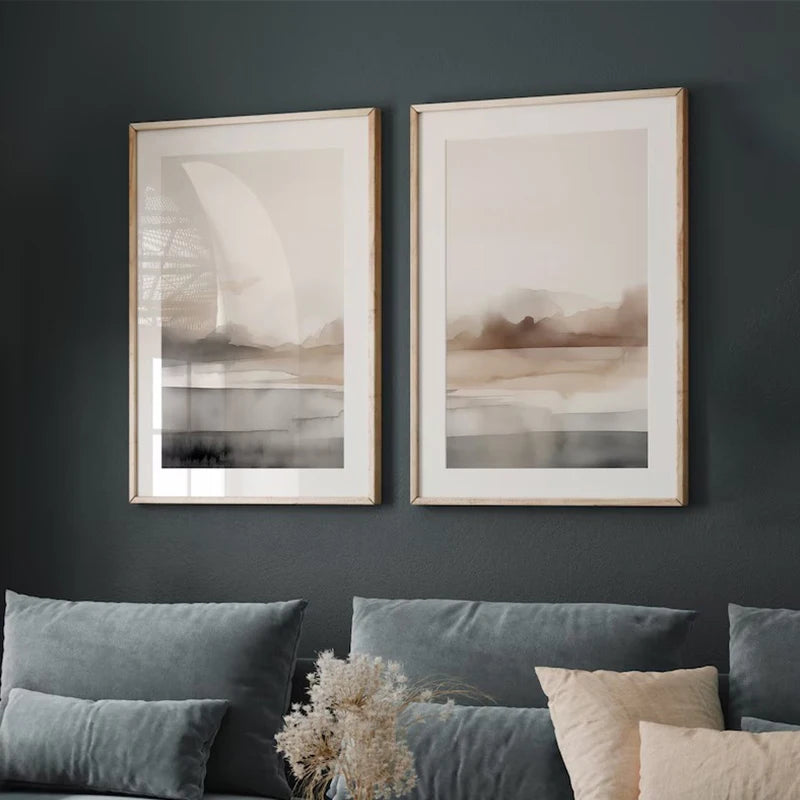 Two framed abstract artworks on a dark wall with a sofa and decorative elements below.