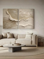 Modern living room with a sectional sofa, coffee table, and wall art depicting waves.