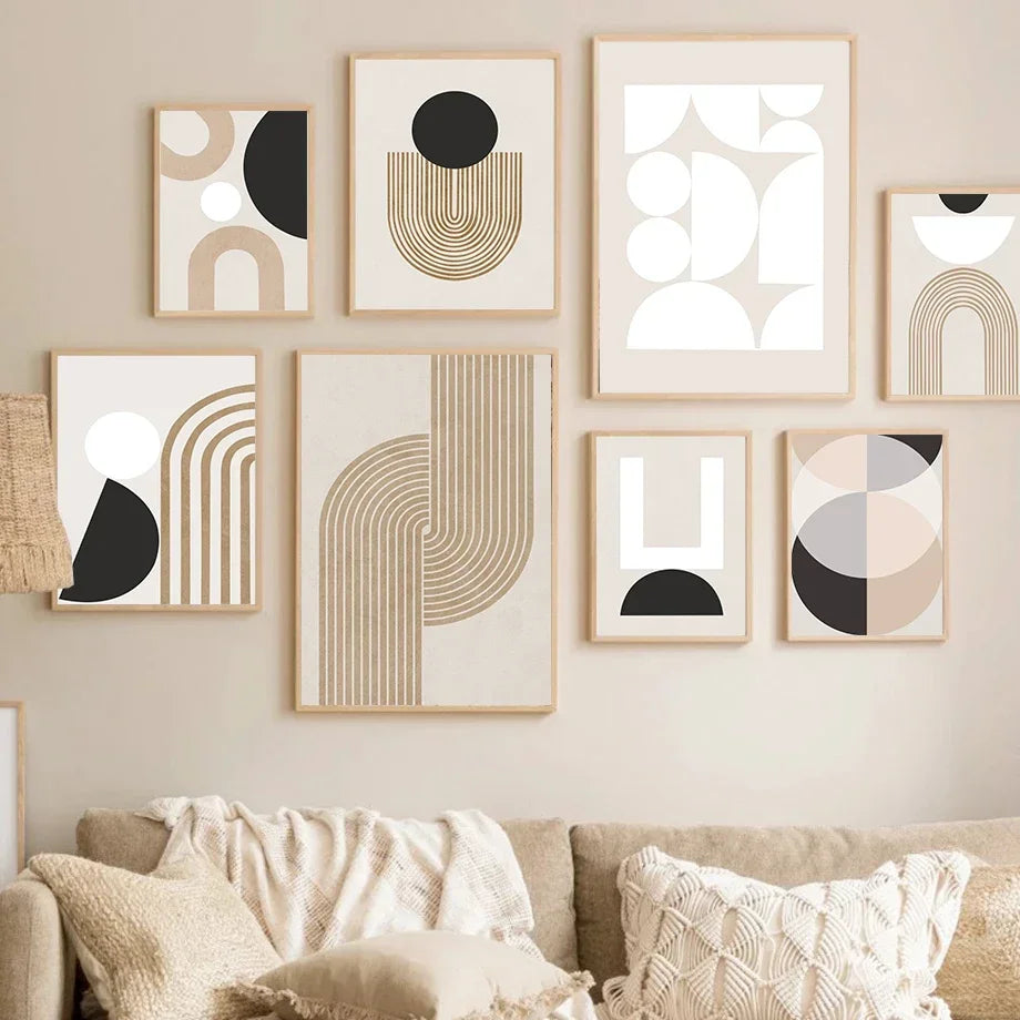 Geometric abstract art prints on a wall above a sofa