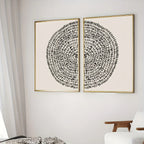 Two abstract art pieces with concentric circles on a white wall.