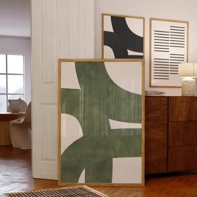 Abstract art pieces on a wall in a modern interior setting
