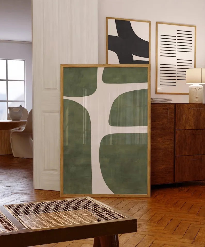 Modern abstract art pieces on a wall in a living room setting.