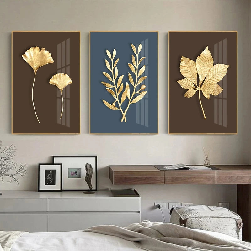 Three framed gold leaf artworks on a wall above a bed.