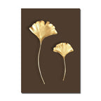 Two gold leaf-shaped wall decorations on a brown background