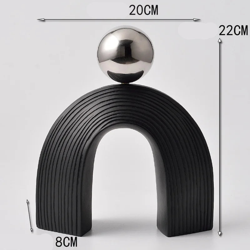 Decorative object with a black arch and silver sphere, shown with measurements on a light gray background.