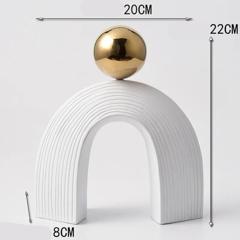 Decorative object with a gold sphere on a white arch, showing dimensions on a light gray background.