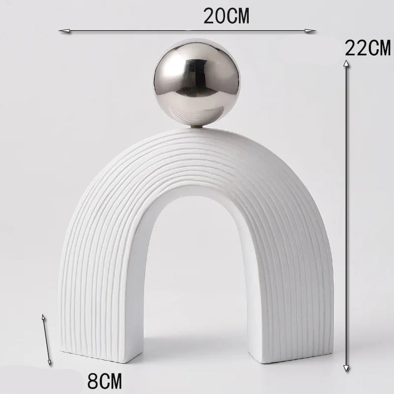 Decorative object with a white arch and silver sphere, shown with measurements on a light gray background.