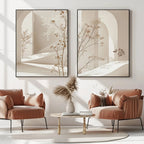 Modern living room with two framed abstract artworks, a coffee table, and pink armchairs.