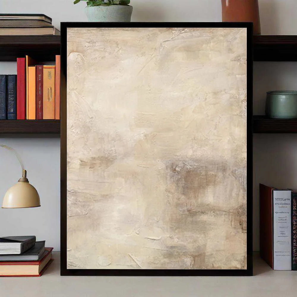 Framed abstract art piece on a shelf with books and decor