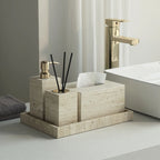 Bathroom setting with a stone-textured caddy holding toiletries next to a bathtub.
