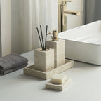 Bathroom setting with concrete holder, soap, and towel on a light surface.