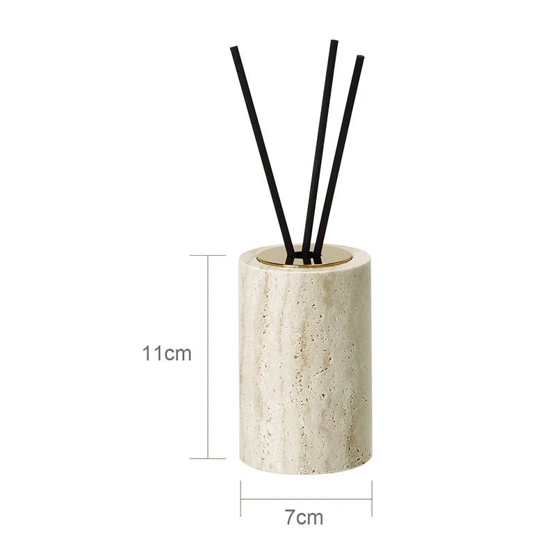 Cylindrical beige diffuser with black sticks on a white background
