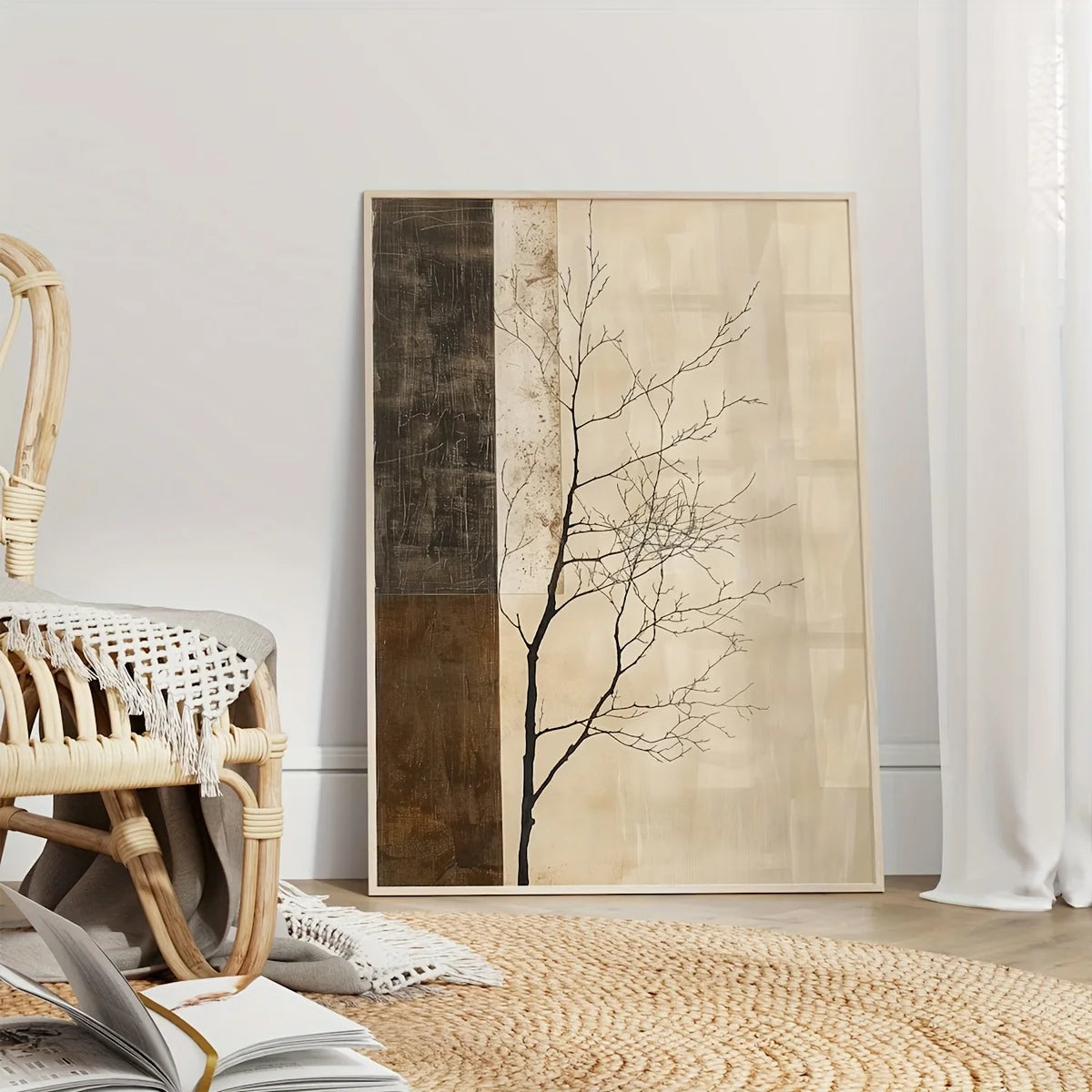 A vertical wall art print leaning against a white wall in a styled room. The artwork features a minimalist black tree silhouette over a split background of dark brown textured panel on the left and warm beige panels on the right.