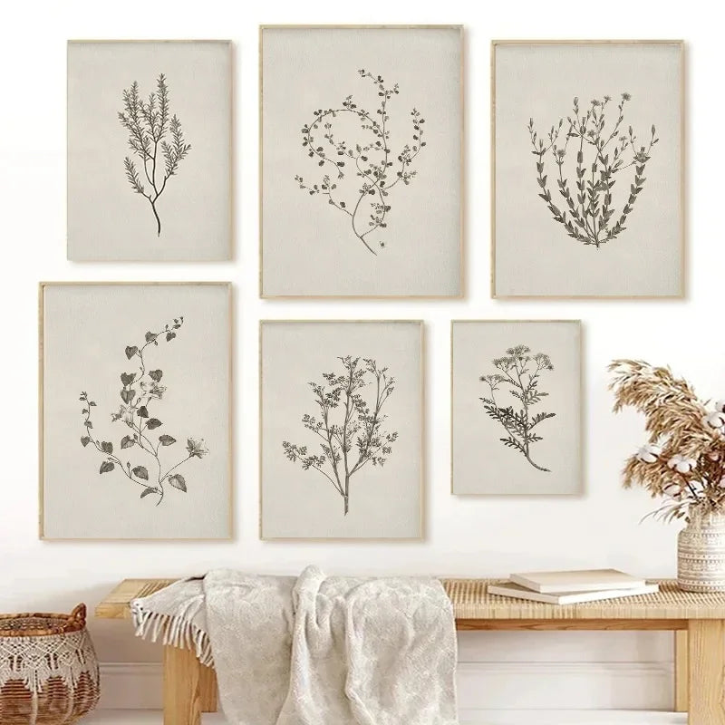 Set of six framed botanical prints on a wall above a wooden bench.