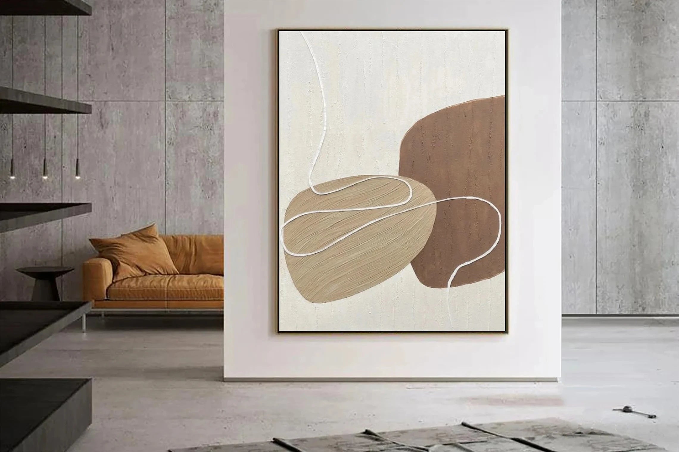 Abstract art piece in a modern living room with a brown sofa and gray walls.