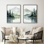 Two framed landscape paintings of mountains and trees over a lake in a living room setting.