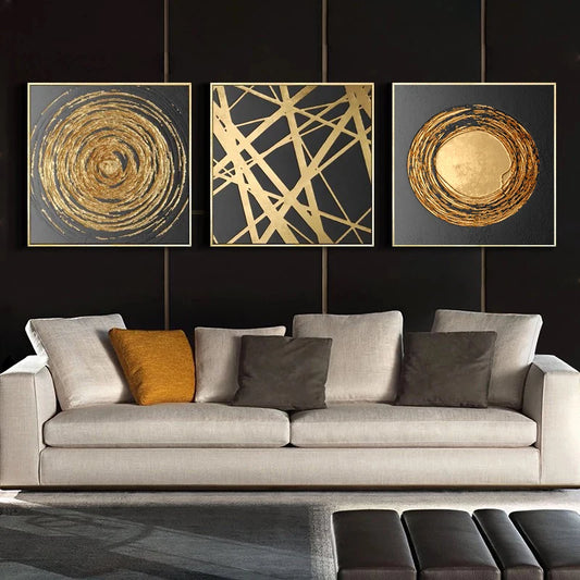 Modern living room with a gray sofa and abstract gold art on a black wall.
