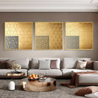 Modern living room with a gray sofa, decorative pillows, and gold wall art.
