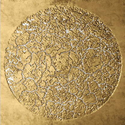 Decorative gold circular design with intricate patterns on a textured gold background