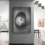 Abstract black and white artwork on a wall in a modern interior setting