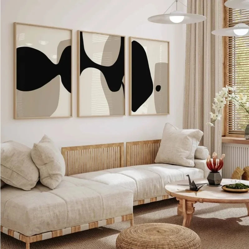 Modern living room with a beige sofa, abstract art, and a small table with decor items.