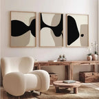 Modern interior with abstract wall art, a beige armchair, and wooden furniture.