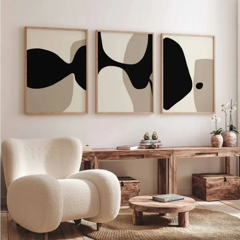 Modern interior with abstract wall art, a beige armchair, and wooden furniture.