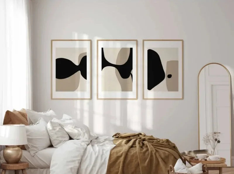 Modern bedroom with abstract wall art and a bed.